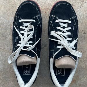 Men’s Simple black suede sneakers with white accents.
